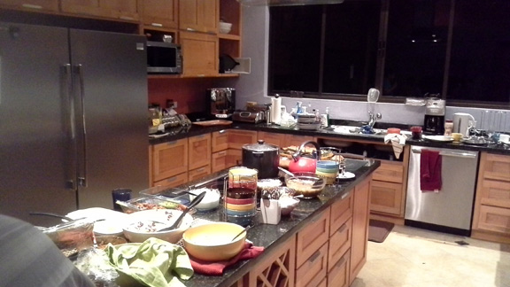 Remember the kitchen shot, above, waiting for its appliances? Look at it now, serving up a potluck dinner!
